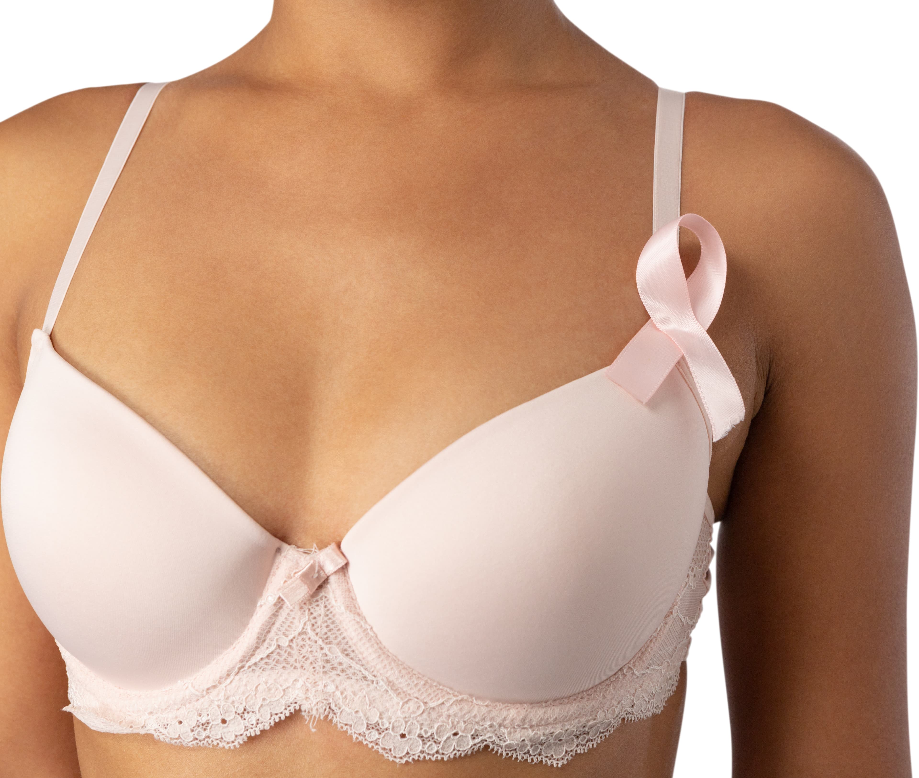 Woman wearing a pink bra with a breast cancer awareness ribbon pinned to the strap.